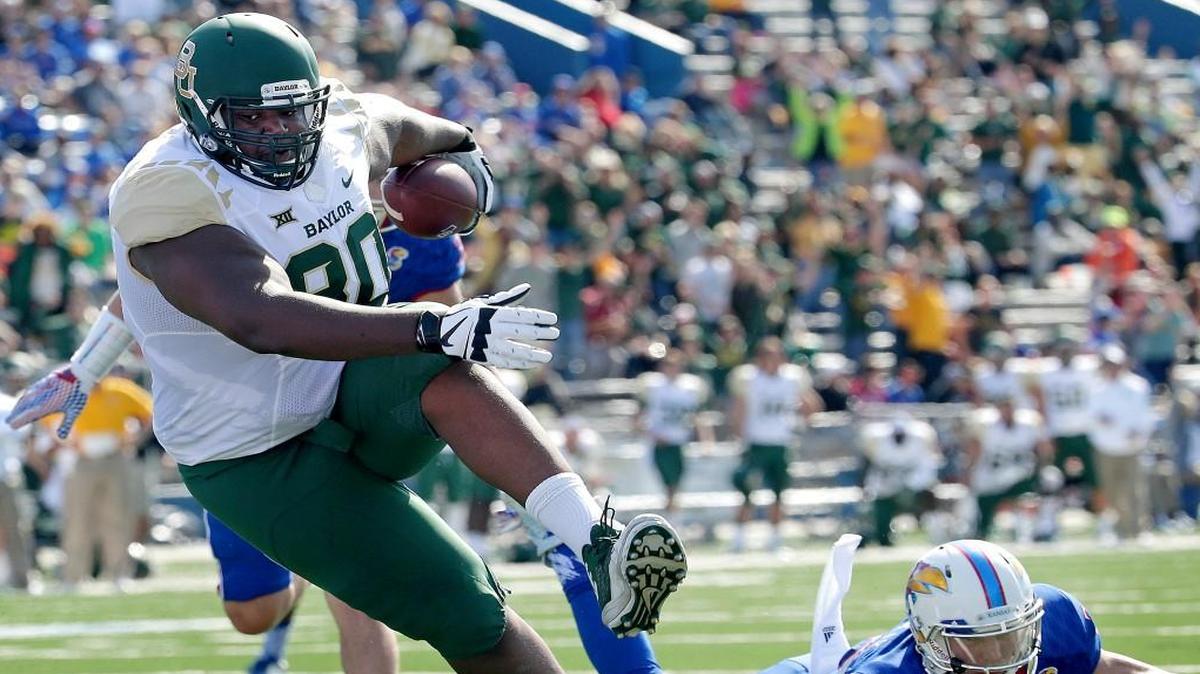 
Baylor tight end LaQuan McGowan (80) gets past Kansas safety Michael Glatczak (39) to score a touchdown during the first half of Friday’s Big 12 college football game in Lawrence.
