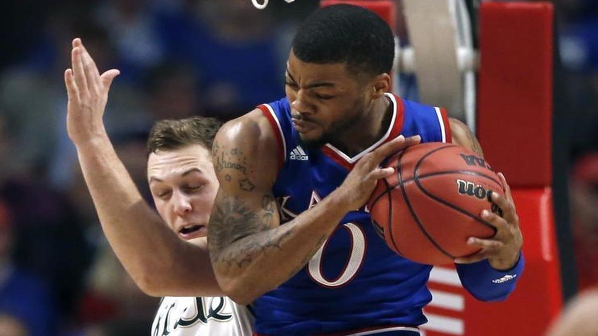 Kansas guard Frank Mason (right) rebounded the ball against Michigan State forward Colby Wollenman in the first half of their Champions Classic game on Tuesday night in Chicago.