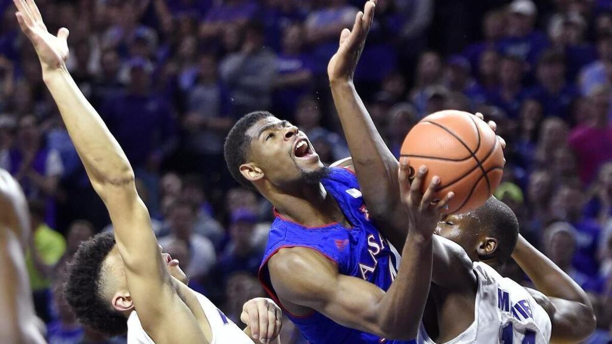 KU’s Malik Newman (center), who scored 13 points Monday against K-State, also grabbed a career-high 10 rebounds.