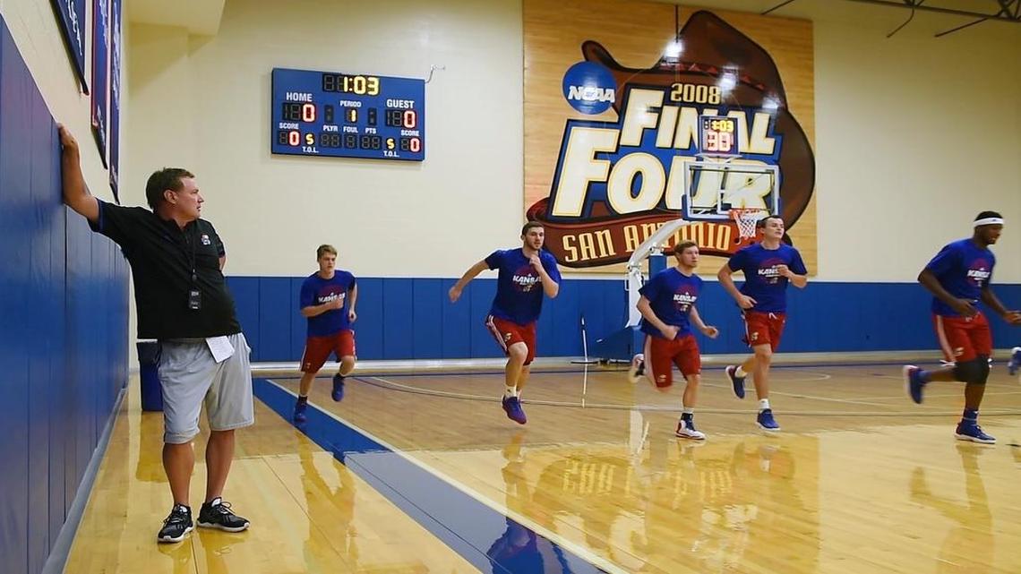 Kansas men’s basketball coach Bill Self (left) at a past early-morning workout.