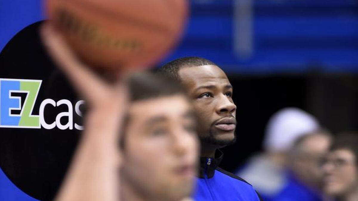 
KU’s Cliff Alexander (rear) watched his teammates warm up for the Jayhawks game against Texas. Alexander did not suit up for the game after questions about his eligibility came up.
