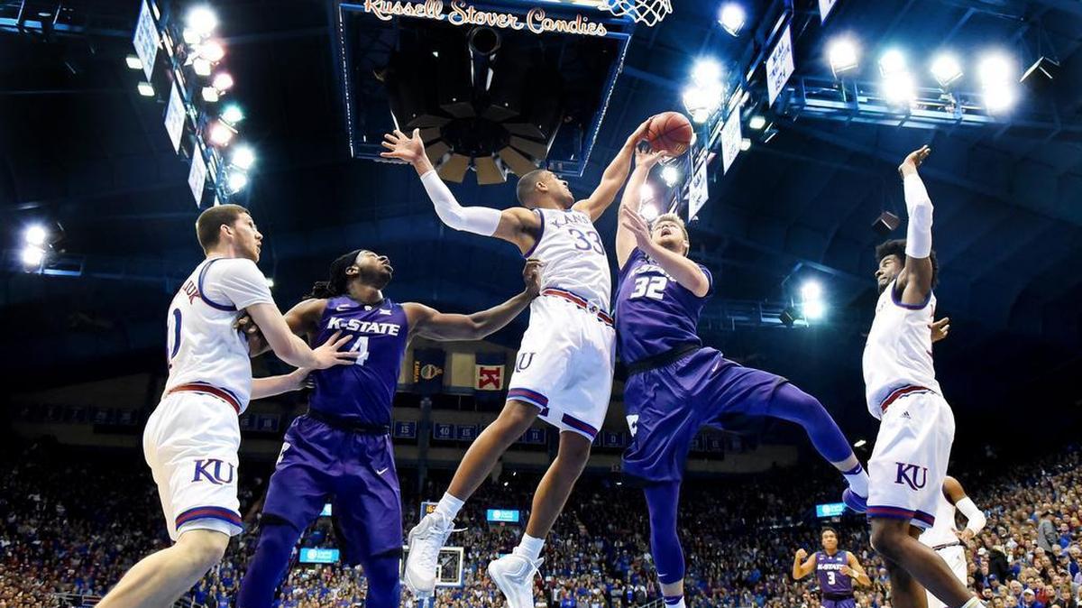 KU's Landen Lucas blocks a shot by KSU's Dean Wade during the first half of Tuesday night's game at Allen Fieldhouse. KU beat K-State, 90-88.