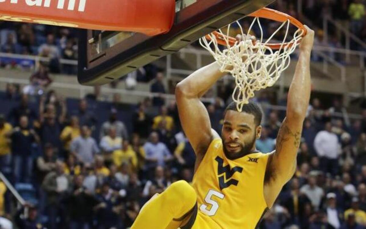 West Virginia guard Jaysean Paige (5) dunks the ball on a fast break during the second half of an NCAA college basketball game against Kansas, Tuesday, Jan, 12, 2016, in Morgantown, W.Va. West Virginia defeated Kansas 74-63. (AP Photo/Raymond Thompson)