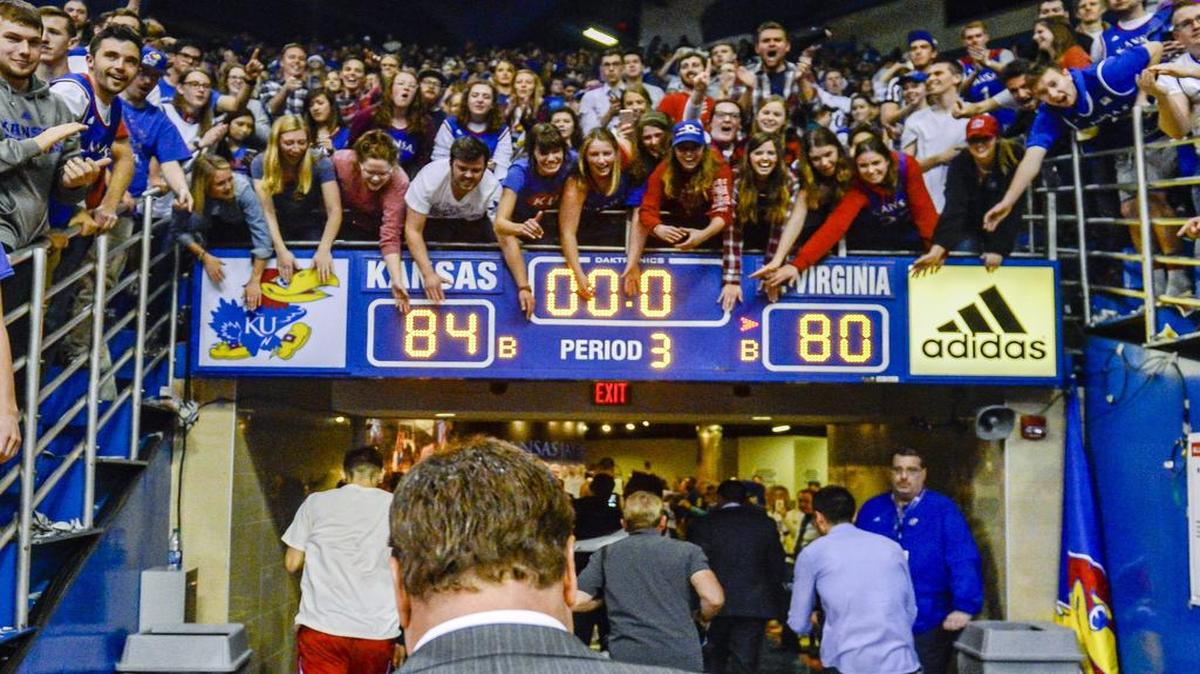 Excited fans celebrate as the Kansas Jayhawks leave the court, including coach Bill Self, after a KU victory over West Virginia at Allen Fieldhouse in Lawrence.