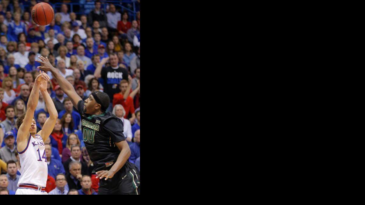 
Kansas guard Brannen Greene shoots a three pointer against Baylor forward Royce O'Neale during the first half on Saturday afternoon at Allen Fieldhouse. 
