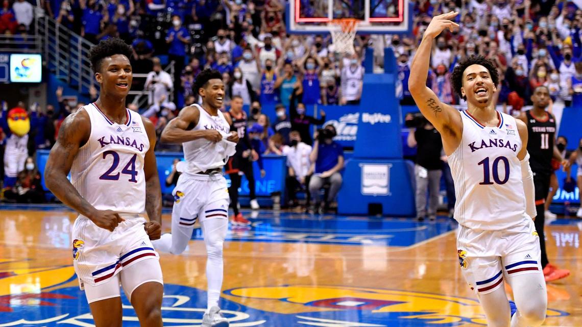 After surviving a 94-91 double overtime thriller over Texas Tech, KU’s KJ Adams, left, Ochai Agbaji and Jalen Willson head toward the KU bench to celebrate Monday night at Allen Fieldhouse.