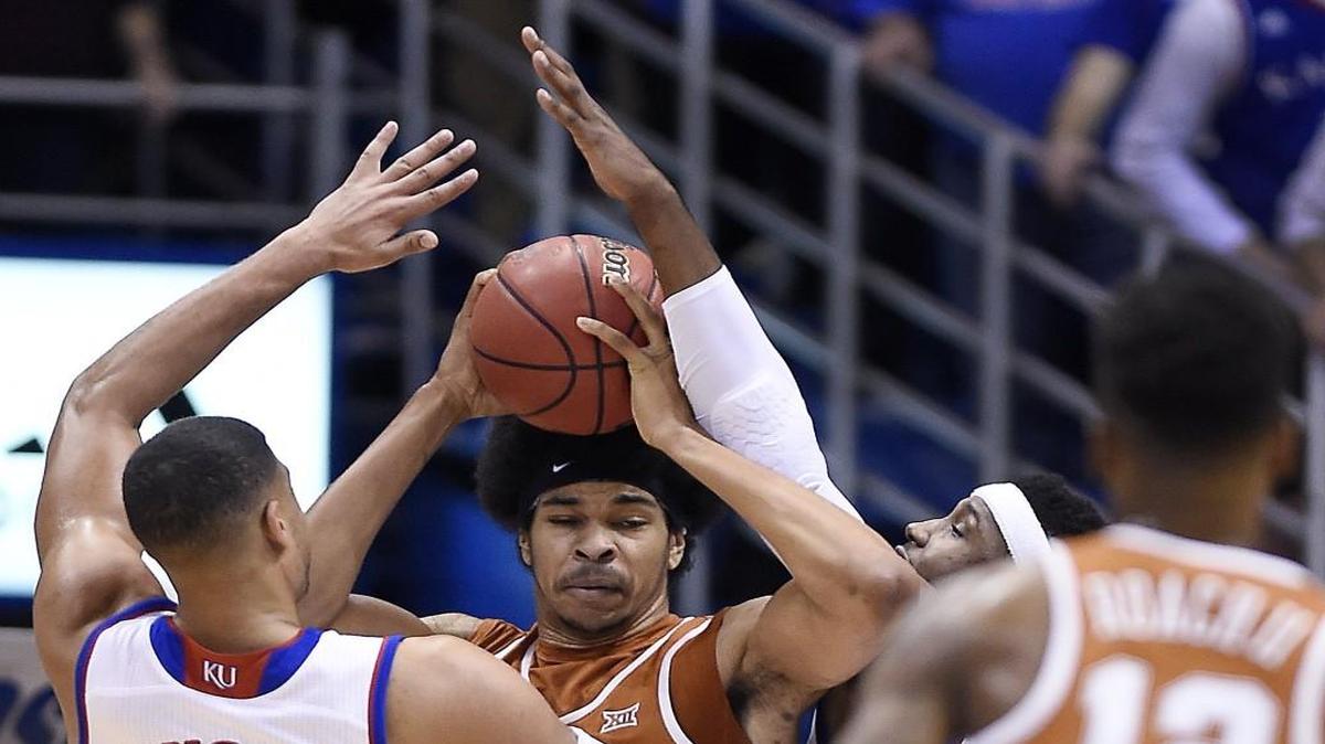 KU teammates Landen Lucas (33) and Carlton Bragg trapped Texas’ Jarrett Allen along the baseline during the first half on Jan. 21 at Allen Fieldhouse. KU beat Texas, 79-67.