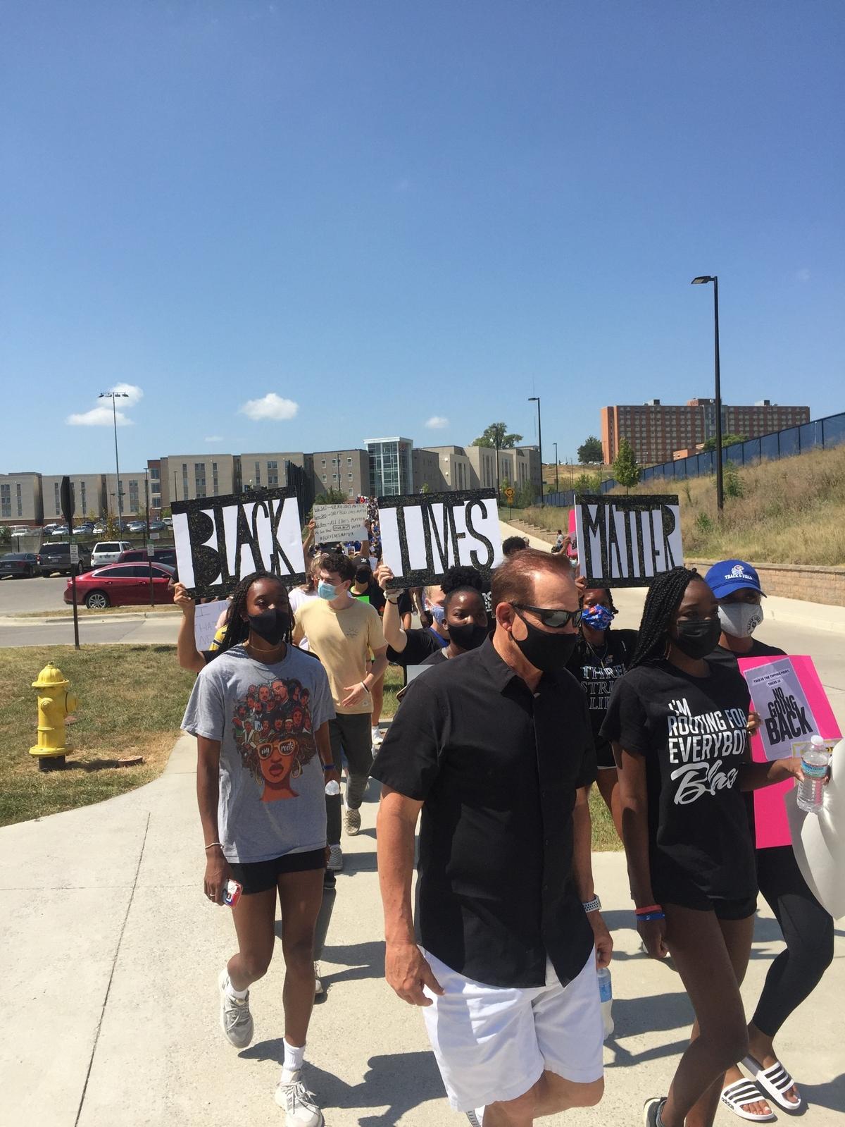 Kansas football coach Les Miles walks with athletes during a march through KU’s campus supporting Black Lives Matter on Friday, Aug. 28, 2020. About 800 people joined in on the walk.