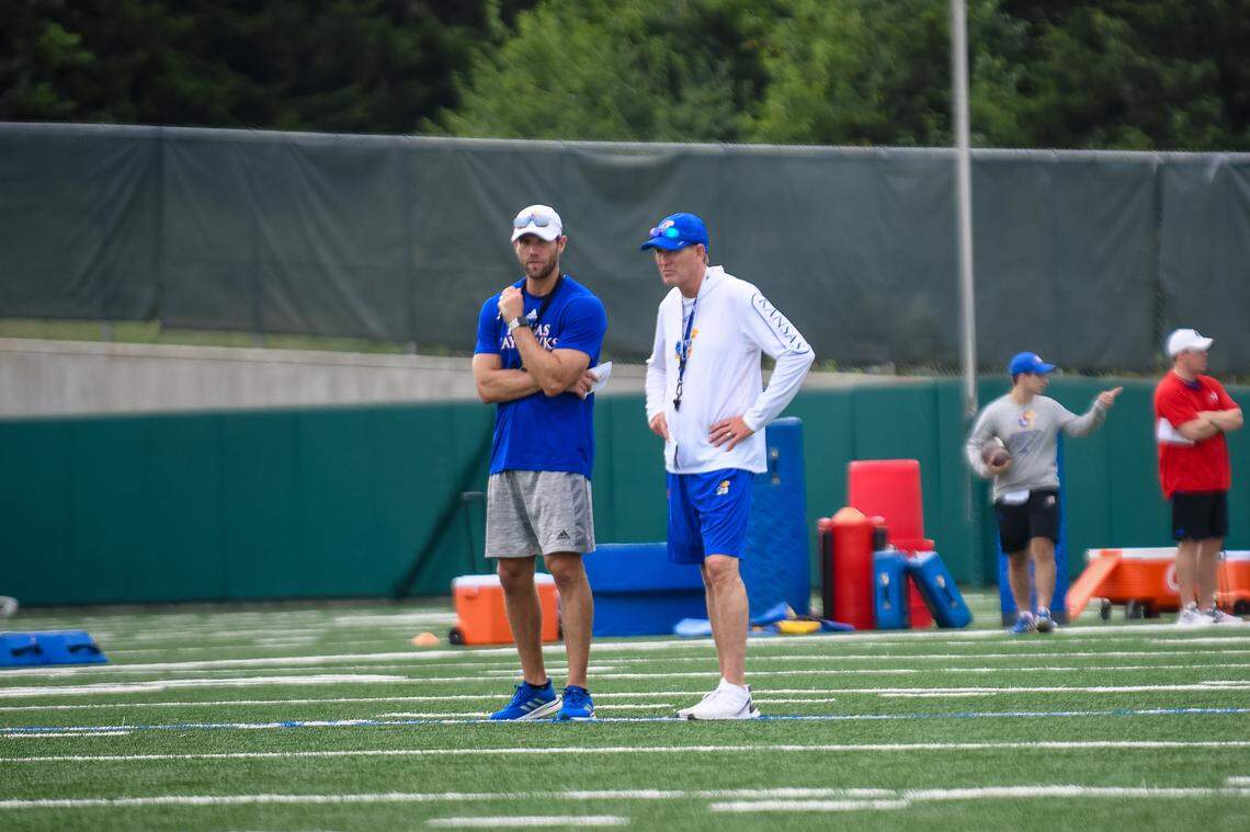 Kansas football strength coach Matt Gildersleeve, left, stands with KU coach Lance Leipold during the first day of practices on Thursday, Aug. 5, 2021, at the KU practice fields in Lawrence, Kansas.