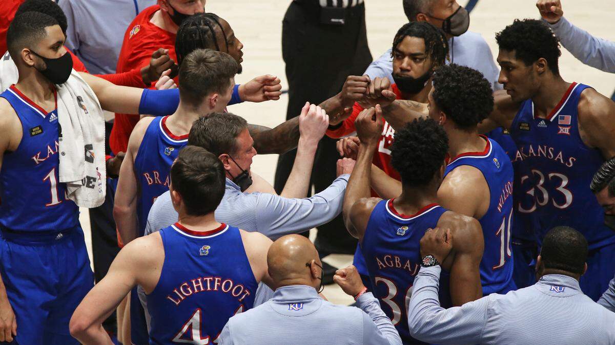 Kansas coach Bill Self meets with players during the second half of a college basketball game against West Virginia, Saturday, Feb. 6, 2021, in Morgantown, W.Va.