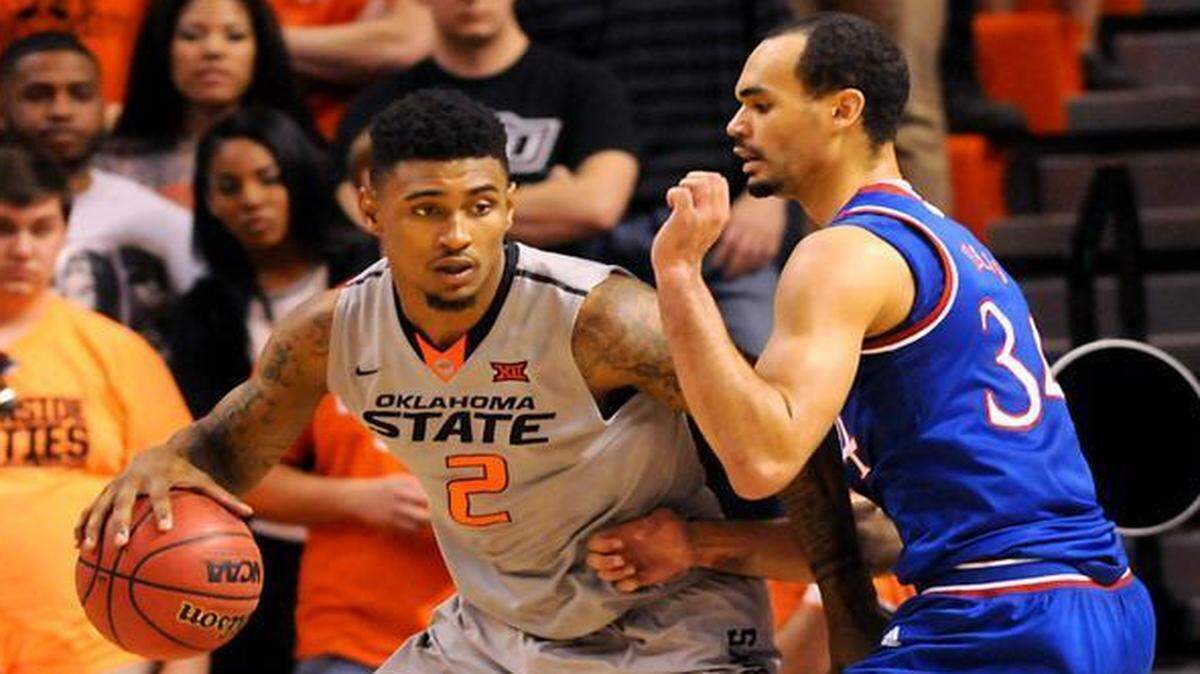 
Kansas forward Ellis Perry (right) defended against Oklahoma State guard Le’Bryan Nash on Saturday in Stillwater, Okla. Nash led Oklahoma State scoring with 18 points in the 67-62 win over Kansas. 
