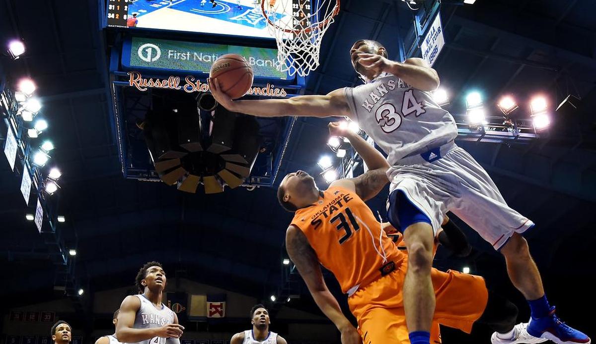 KU’s Perry Ellis (34) sailed by OSU’s Chris Olivier for the reverse layup at Allen Fieldhouse on Feb. 15, 2016. KU beat Oklahoma State 94-67.