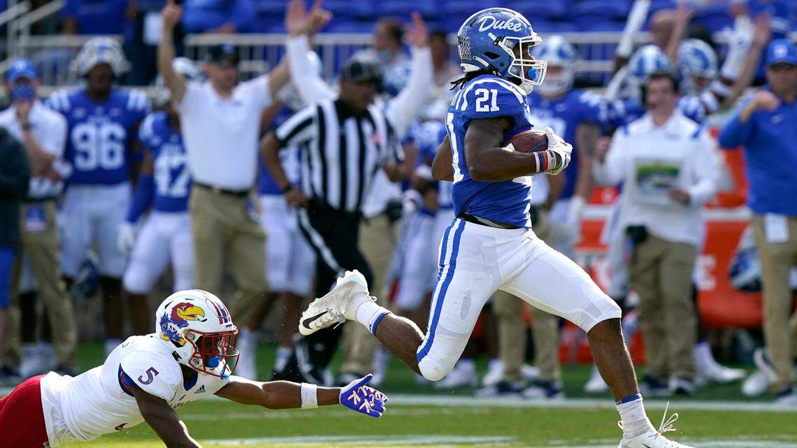 Duke running back Mataeo Durant (21) runs for a touchdown while Kansas safety O.J. Burroughs (5) misses the tackle during the first half of a game in Durham, N.C., Saturday, Sept. 25, 2021.