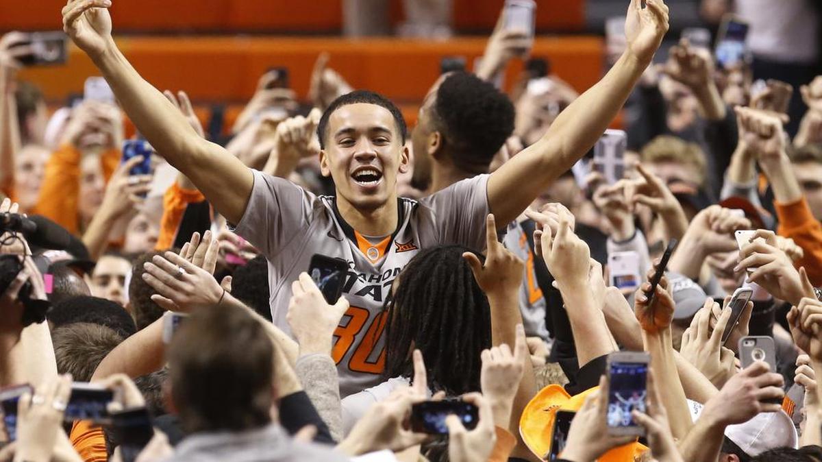 Oklahoma State guard Jeffrey Carroll (30) celebrates with fans after Oklahoma State defeated Kansas in an NCAA college basketball game in Stillwater, Okla., Tuesday, Jan. 19, 2016. Oklahoma State won 86-67. (AP Photo/Sue Ogrocki)