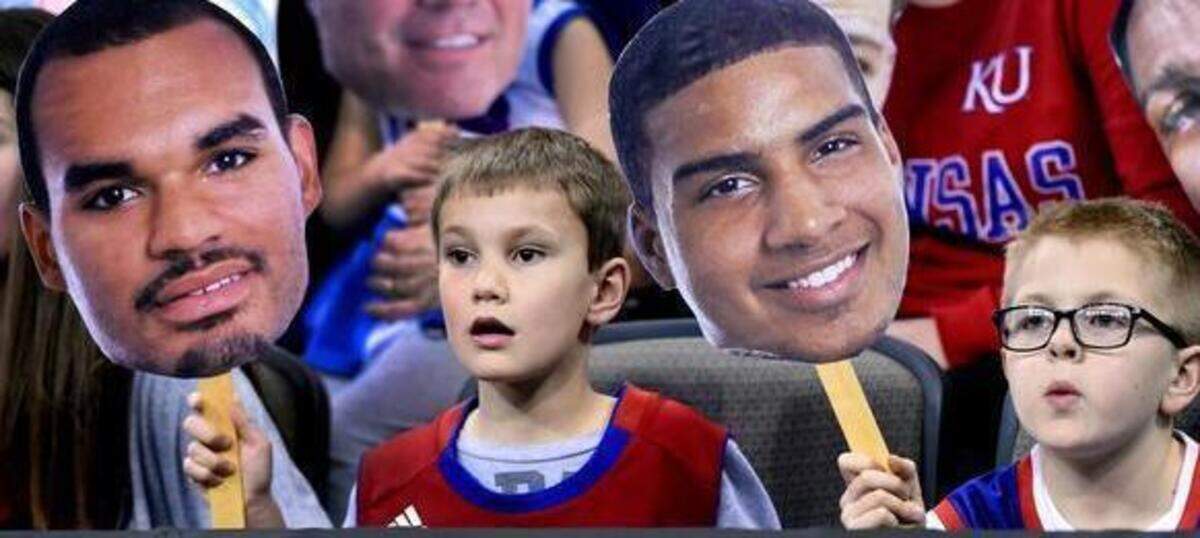 
Anthony Menghini, 6, (left) and Anderson Rowcroft, 8, had front row seats for KU’s shoot-around Thursday at the CenturyLink Center in Omaha. Both were with their families from Shawnee. Anthony held a Perry Ellis cutout and Anderson is a Landen lucas fan. KU will take on New Mexico State Friday morning in the NCAA Tournment.
