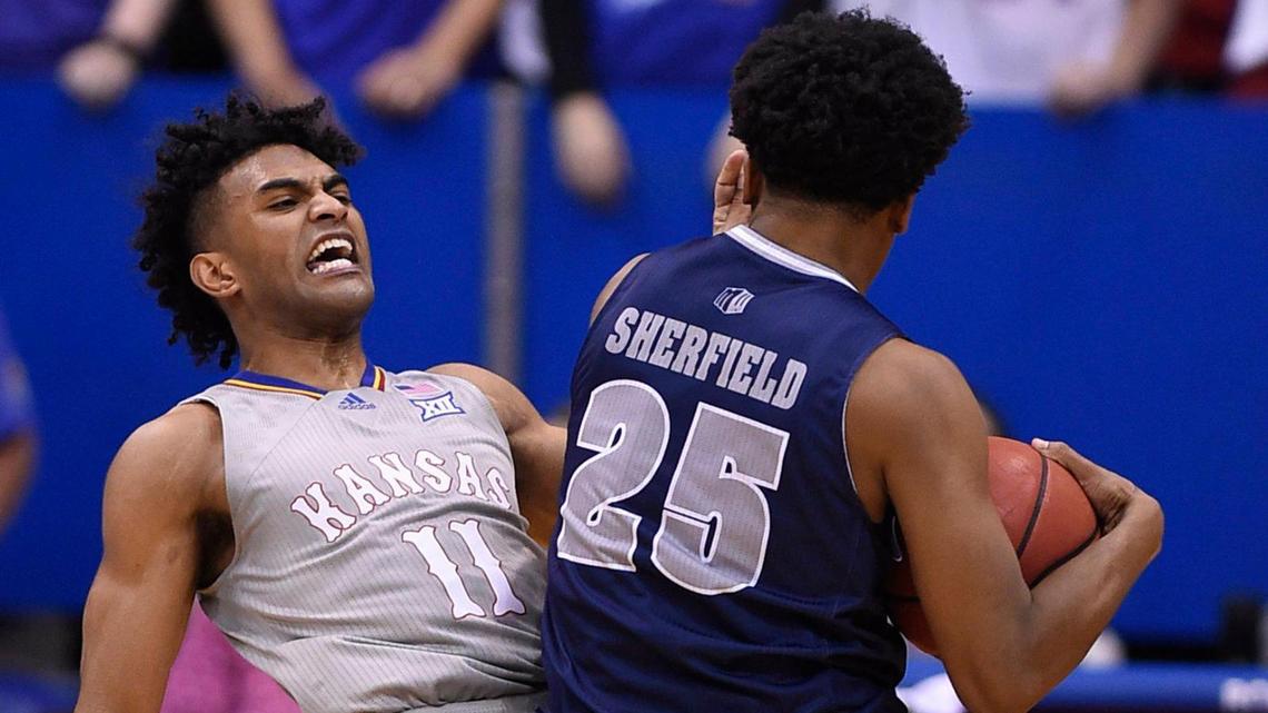 KU point guard Remy Martin got hit with a blocking foul while trying to take a charge on Nevada’s Grant Sherfield during the second half of Wednesday night’s game at Allen Fieldhouse. KU beat Nevada, 88-61.