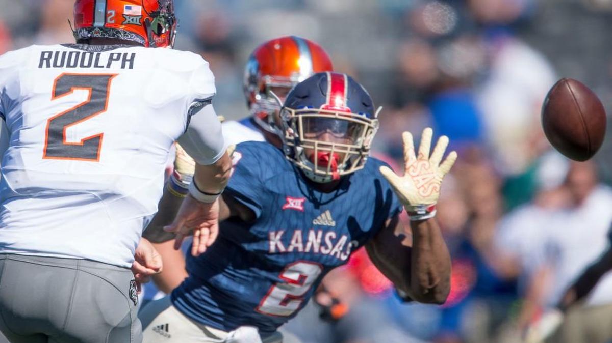 Kansas defensive end Dorance Armstrong Jr. (No. 2) applies pressure to Oklahoma State quarterback Mason Rudolph during Saturday’s game in Lawrence.