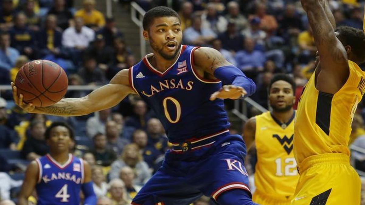 Kansas guard Frank Mason looked to pass while being guarded by West Virginia’s Daxter Miles Jr. in their game Jan. 12 in Morgantown, W.Va.