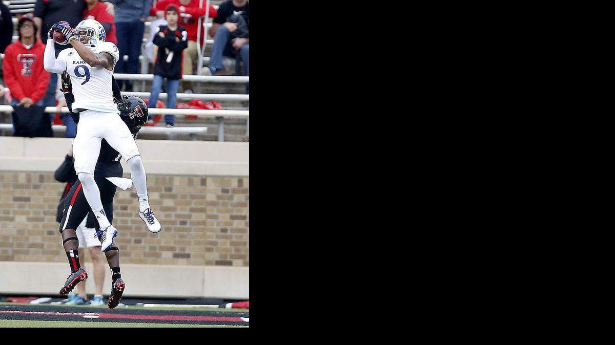
Kansas' Nigel King makes a catch over Texas Tech's Nigel Bethel II during an NCAA college football game in Lubbock, Texas, Saturday, Oct. 18, 2014. 
