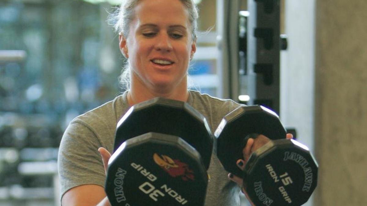 In this July 2013 file photo, Andrea Hudy, the then assistant athletic director for sports performance at the University of Kansas, spotted Marine Sgt. Michael Pride of the Wounded Warrior Project as Pride learned techniques and philosophies of training that he wanted to transfer to his athletes at Fort Leonard Wood, Mo. 