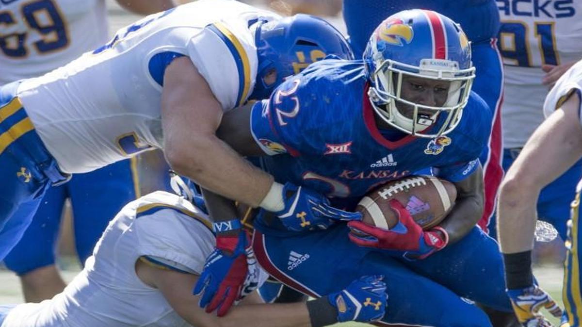 
Kansas Jayhawks running back Ke’aun Kinner dragged a couple of South Dakota State defenders as he worked for extra yards on Saturday.
