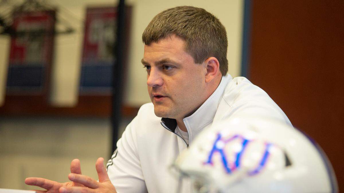 Kansas special teams coach Jake Schoonover talks during a media availability on May 18, 2021 at Anderson Family Football Complex in Lawrence, Kan. Schoonover says one his biggest goals with KU is to build trust with high school players in the Kansas and Kansas City area.