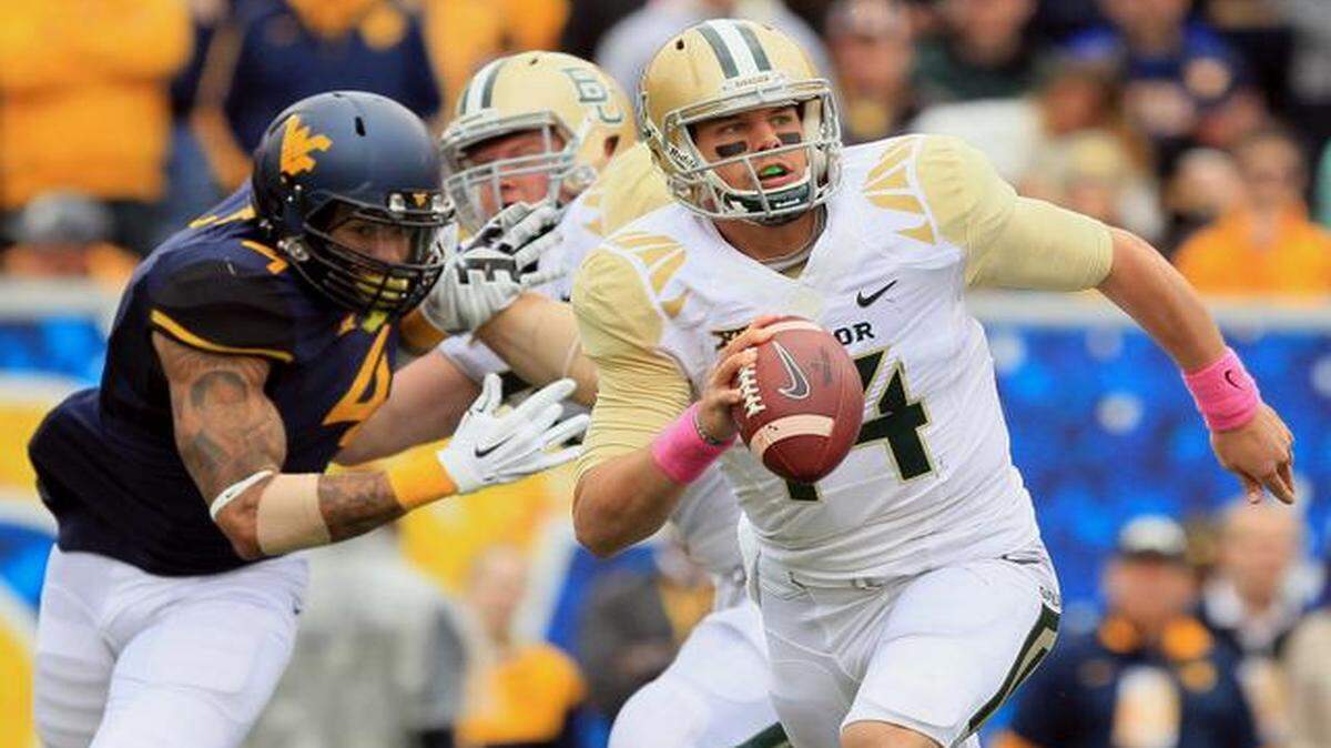 
West Virginia’s Shaquille Riddick (left) got around a Baylor lineman on his way to sack Baylor quarterback Bryce Petty (14) two weeks ago in Morgantown, W.Va. West Virginia won 41-27, giving the Bears their first loss of the season.


