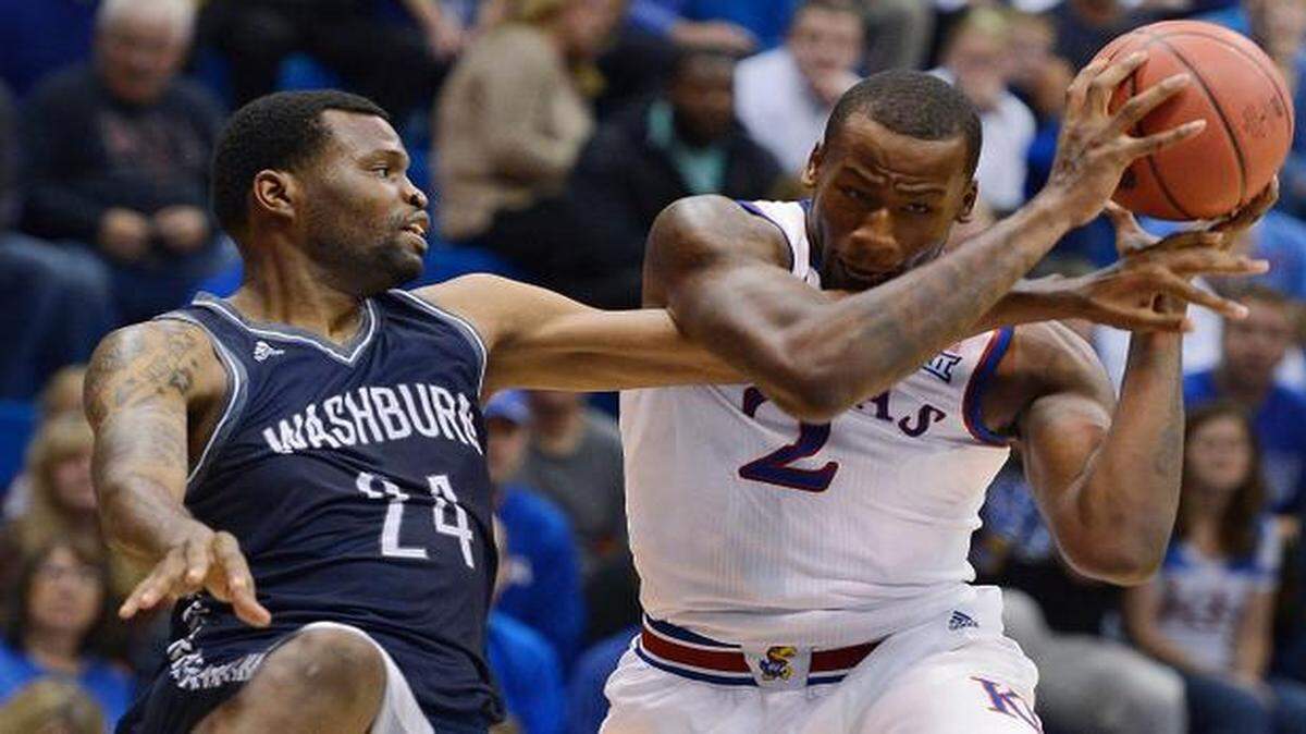 
KU's Cliff Alexander (right), who had 10 points, four rebounds and three blocks in the opening half, ripped an offensive rebound away from Washburn's Stephon Drane and then completed the stick-back during Monday night's game at Allen Fieldhouse.
