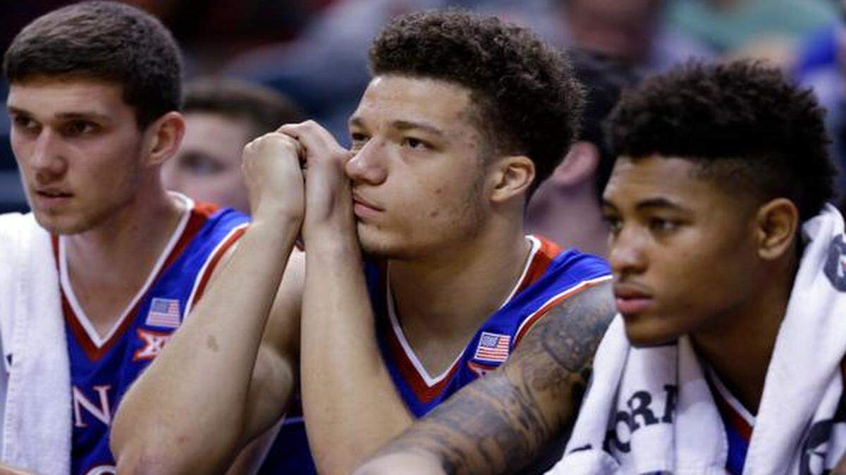 
Kansas players (from left) Sviatoslav Mykhailiuk, Brannen Greene and Kelly Oubre Jr. watched as the final minutes ticked off in the No. 5-ranked Jayhawks’ 72-40 defeat to No. 1 Kentucky on Tuesday night at the Champions Classic in Indianapolis.

