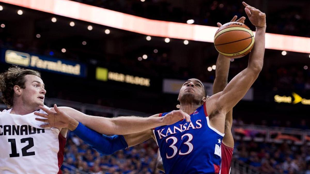 
Team Canada forward Chris McLaughlin (12) and University of Kansas forward Landen Lucas (33) battled for a rebound as the two teams met in an exhibition game Tuesday night at Sprint Center in preparation for the World University Games next month in South Korea.
