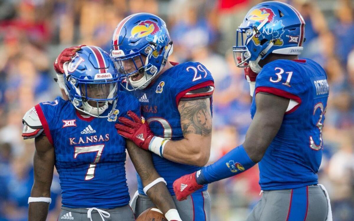 Kansas cornerback Derrick Neal (7) held the ball as Jayhawks linebackers Joe Dineen Jr. (29) and Osaze Ogbebor (31) congratulated him on breaking up a pass in the second quarter during the Univerisity of Kansas and Southeast Missouri State football game at Memorial Stadium on Saturday, September 2, 2017.