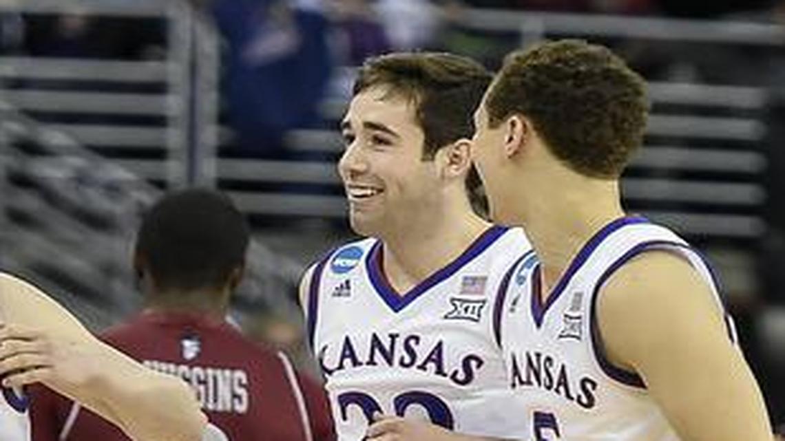 
Kansas Jayhawks reserve players Kansas Jayhawks guard Tyler Self (11), guard Josh Pollard (22), guard Evan Manning (5) and guard Christian Garrett (15) smiled as they closed out the 75-56 win over the New Mexico State Aggies during the second round of the NCAA men’s basketball tournament on March 20, 2015, at CenturyLink Center in Omaha, Neb.
