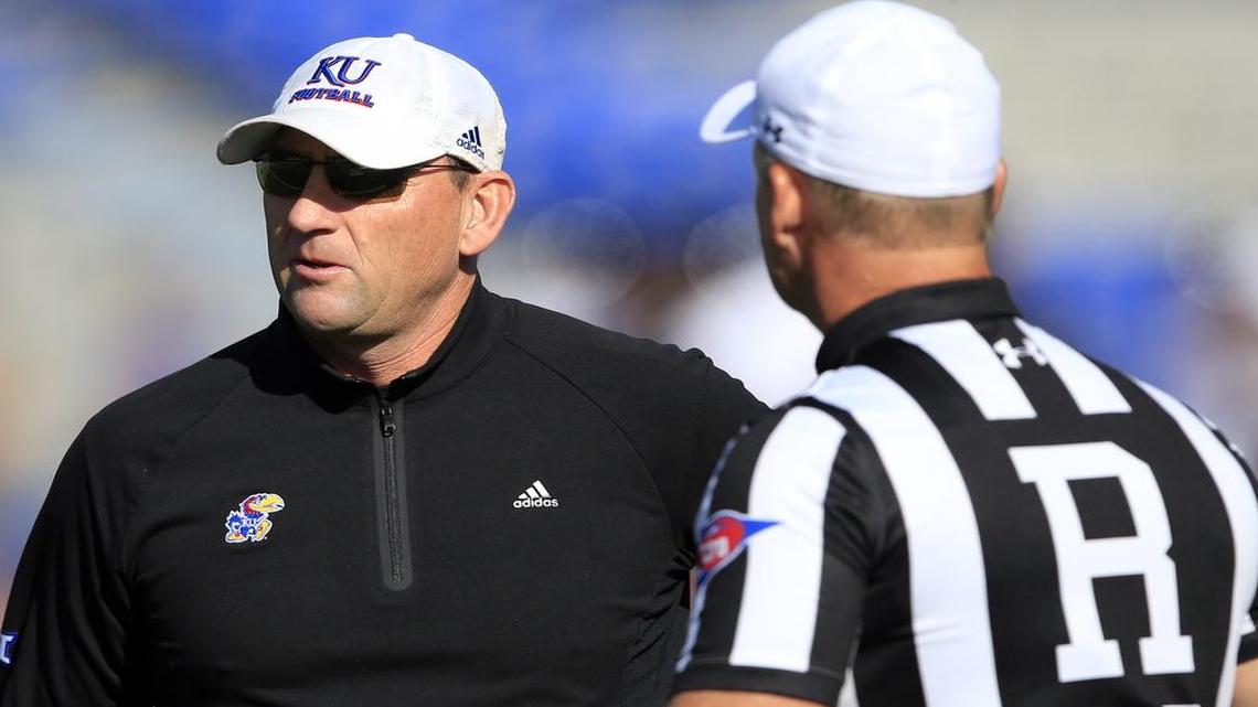 Kansas head coach David Beaty (left) talked with one of the officials during the first half of Saturday’s game against Texas Tech at Memorial Stadium in Lawrence.