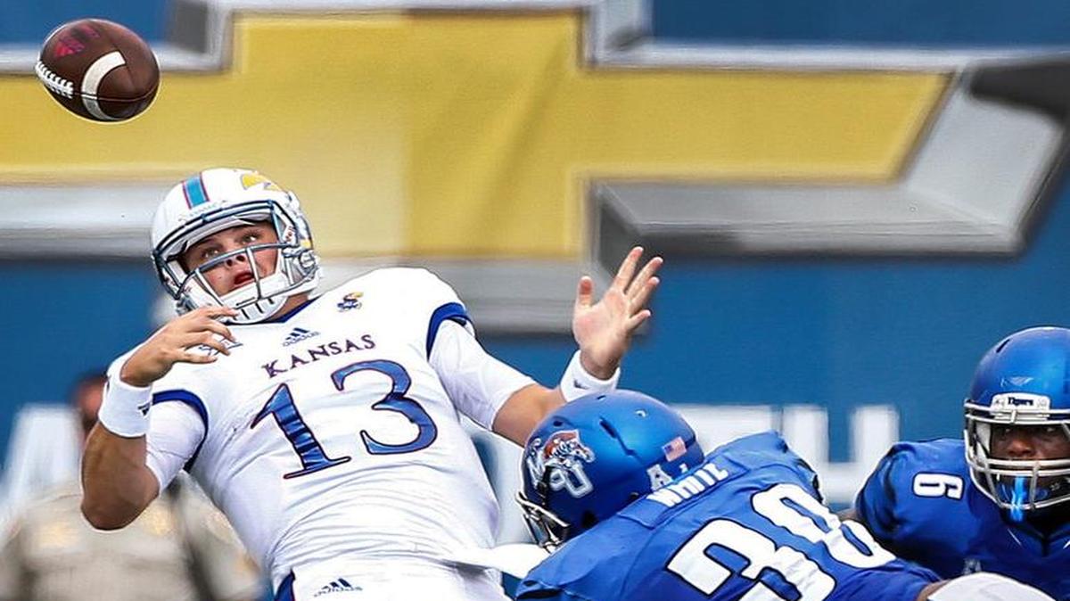 KU quarterback Ryan Willis (left) fumbled the ball after an attack by Shareef White of Memphis in the first quarter Saturday at Liberty Bowl Memorial Stadium.