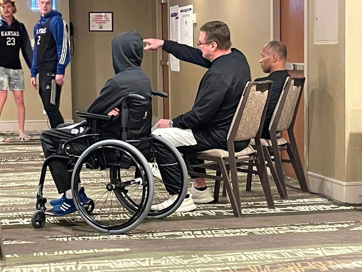 JP Bemberger of Lenexa, Kansas, left, talks over a Kansas basketball film session with KU coach Bill Self ahead of the team’s Elite Eight game against Miami (Florida) in Chicago.
