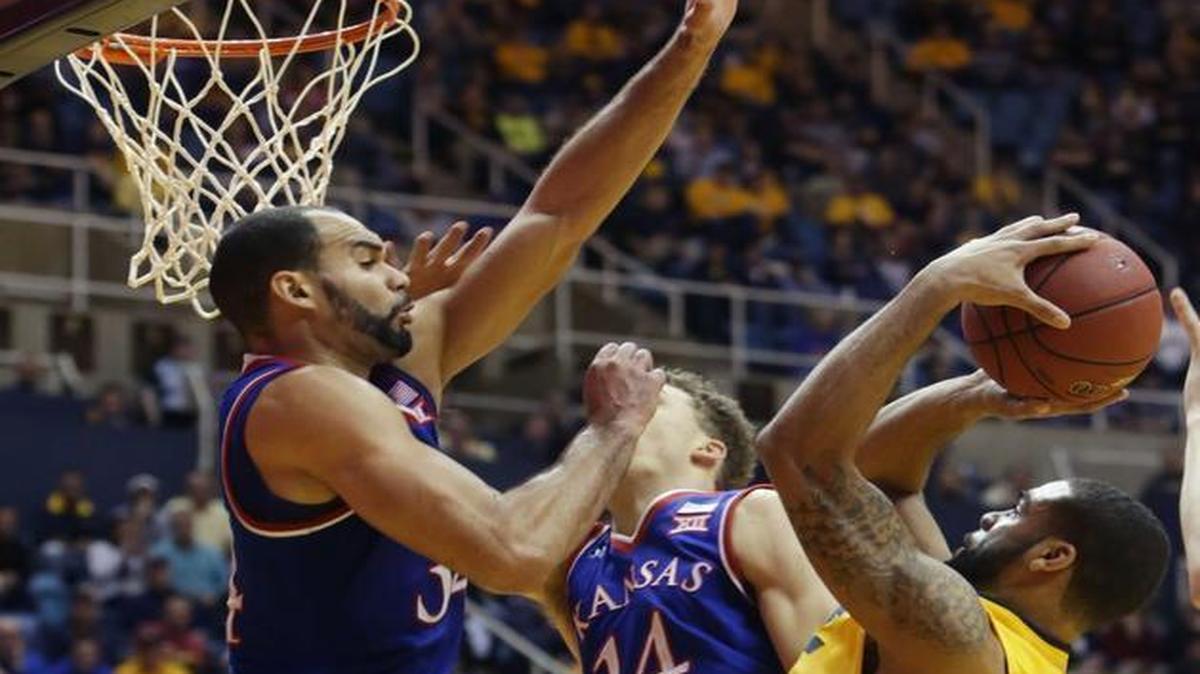 West Virginia guard Jaysean Paige (5) drove to the basket defended by Kansas forward Perry Ellis (34) when the Mountaineers beat the Jayhawks 74-63 on Jan. 12 in Morgantown, W.Va. On Tuesday night, the Mountaineers, now leading the Big 12, play the Jayhawks at Allen Fieldhouse in Lawrence.