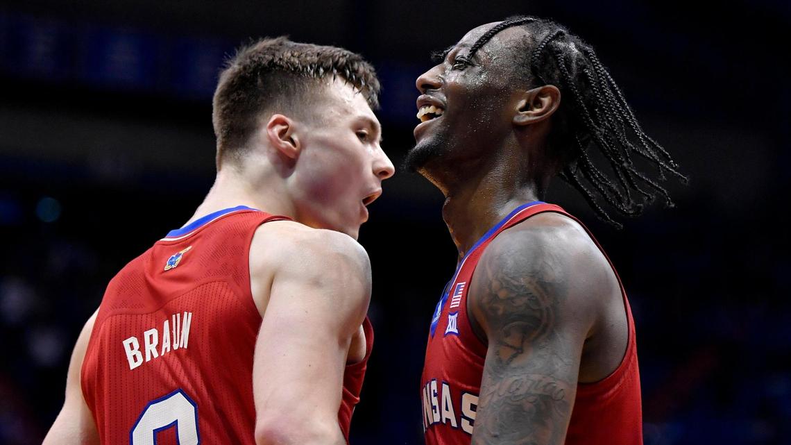 KU senior Marcus Garrett celebrates with teammate Christian Braun as the final seconds expire during the Jayhawks 71-58 win Saturday night over Baylor at Allen Fieldhouse.
