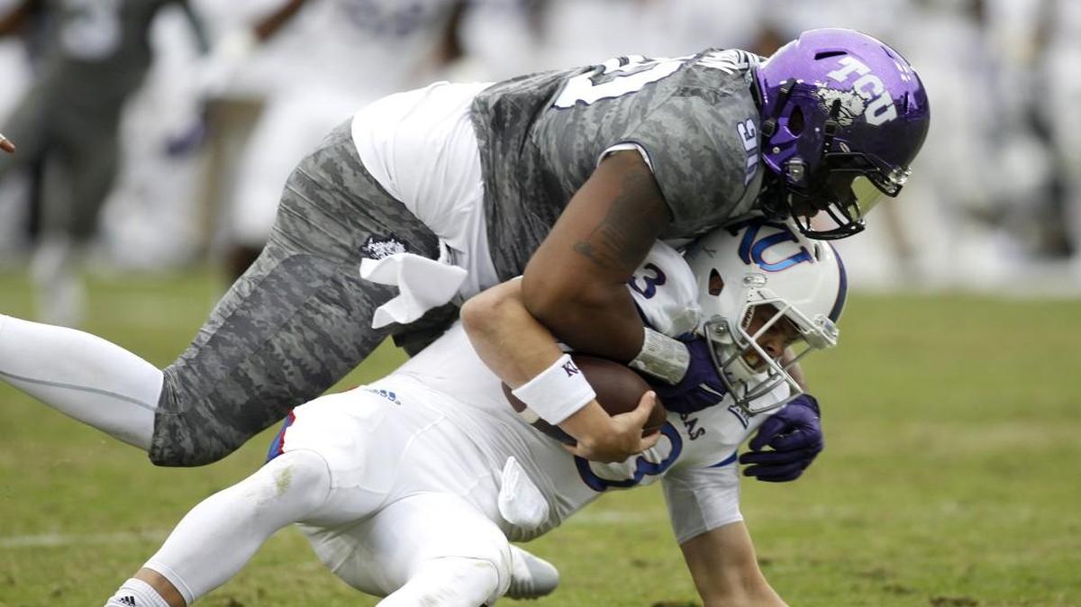 TCU defensive end Terrell Lathan sacked Kansas quarterback Ryan Willis late in the fourth quarter.