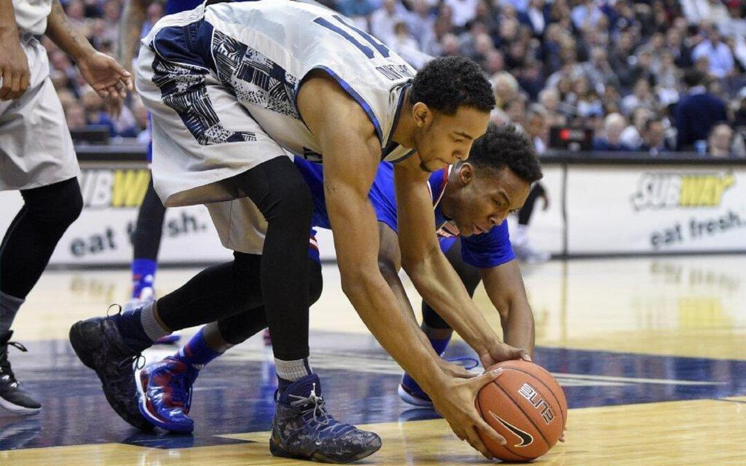 Georgetown’s Isaac Copeland (left) battled KU’s Devonte Graham for the ball in a 2014 game in Washington. Copeland, who played with Graham in AAU and prep school ball, recently announced plans to leave Georgetown.