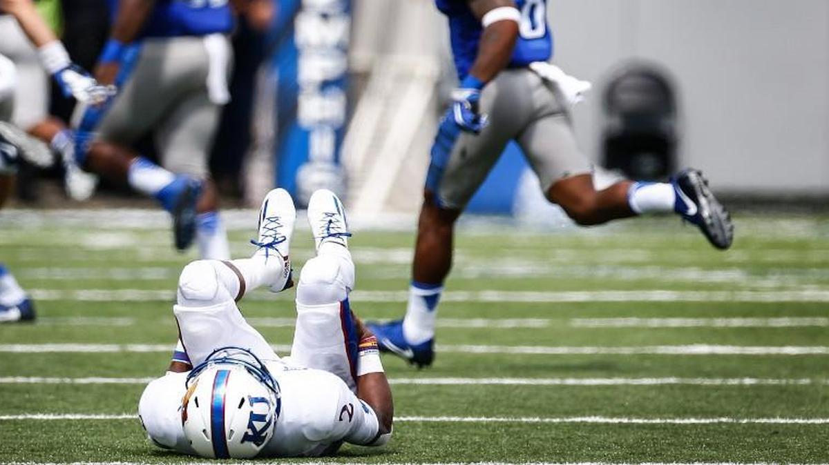 KU quarterback Montell Cozart lay on the field after throwing an interception that resulted in a Memphis touchdown in the second quarter Saturday at Liberty Bowl Memorial Stadium.