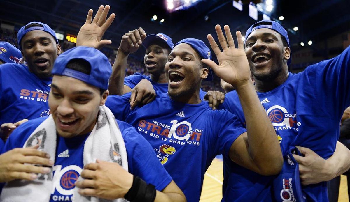 Kansas players got to officially celebrate their 10th consecutive Big 12 Conference title on March 5, 2014 with a 82-57 thumping of Texas Tech at Allen Fieldhouse. Seniors Niko Roberts (left front) and Tarik Black (right) got to model special hats and T-shirts with teammates Jamari Traylor, Andrew Wiggins and Wayne Selden after the game.