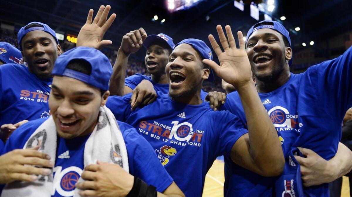 Kansas players got to officially celebrate their 10th consecutive Big 12 Conference title on March 5, 2014 with a 82-57 thumping of Texas Tech at Allen Fieldhouse. Seniors Niko Roberts (left front) and Tarik Black (right) got to model special hats and T-shirts with teammates Jamari Traylor, Andrew Wiggins and Wayne Selden after the game.