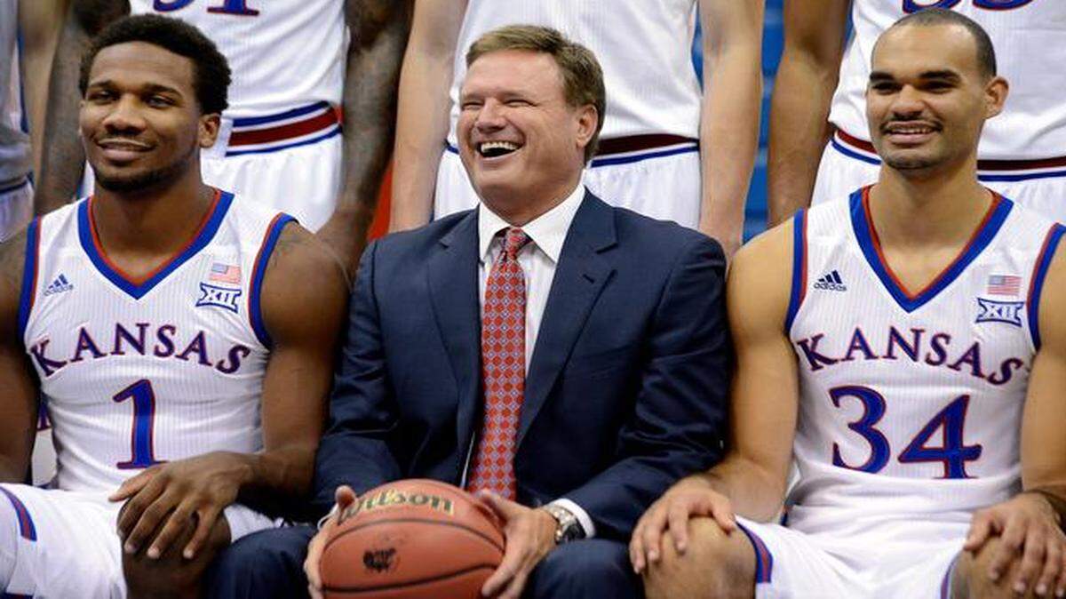 
Someone always manages to crack a joke while the official team picture is being made, and Thursday was no exception for KU coach Bill Self (middle) and his 2014-15 Jayhawks. Veteran starters Wayne Selden Jr. (left) and Perry Ellis are back for another season.
