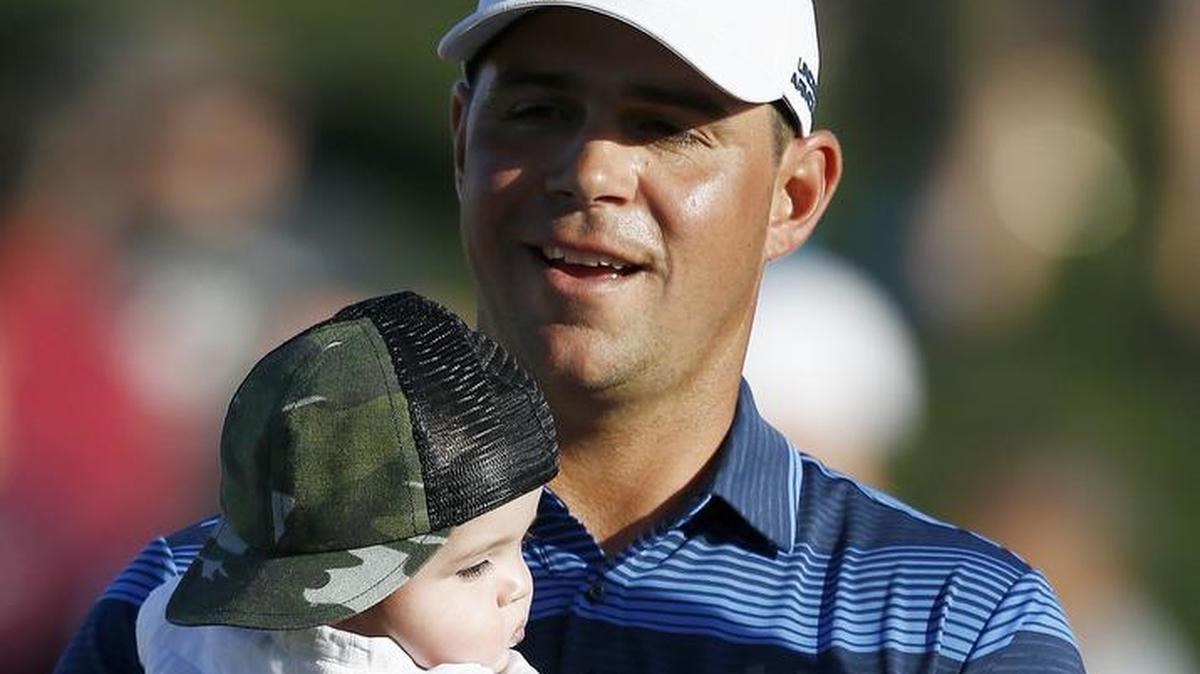 Former KU golfer Gary Woodland held his son, Jaxson, after winning the Waste Management Phoenix Open in a playoff on Sunday. Kansas basketball coach Bill Self talked to Woodland on the phone after his victory.