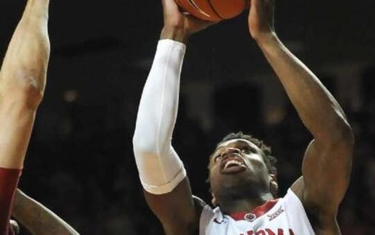 Oklahoma guard Buddy Hield (right) scored 22 points against Iowa State in the Sooners’ 87-83 win Saturday in Norman, Okla.
