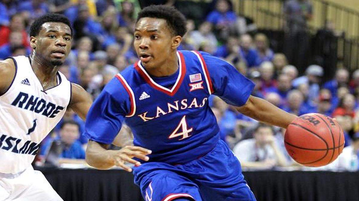 
Kansas guard Devonte' Graham (4) drove past Rhode Island’s Jarvis Garrett (1) during their game last month in Lake Buena Vista, Fla.
