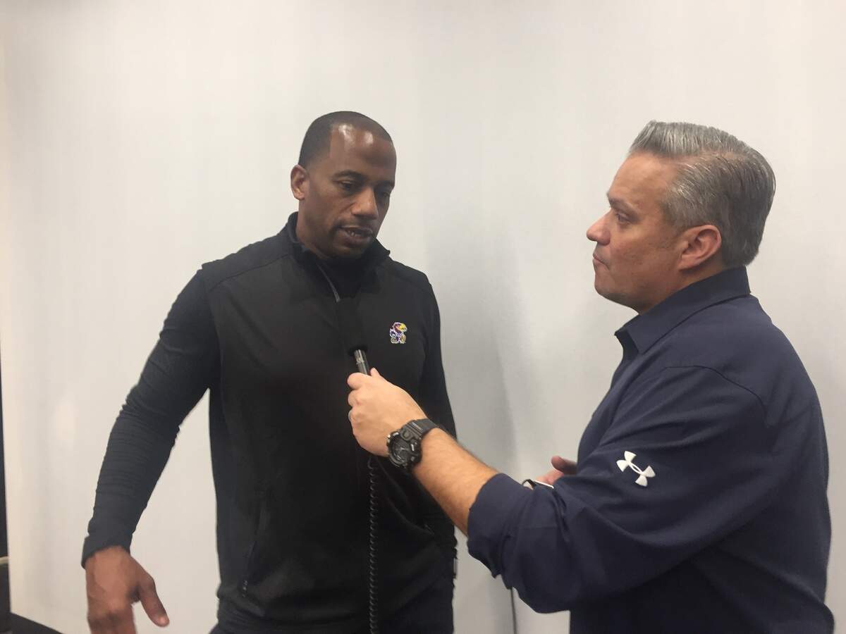 Kansas football receivers coach/passing game coordinator Emmett Jones, left, talks to a reporter during an interview in on Feb. 6, 2019, at KU’s Anderson Family Football Complex.