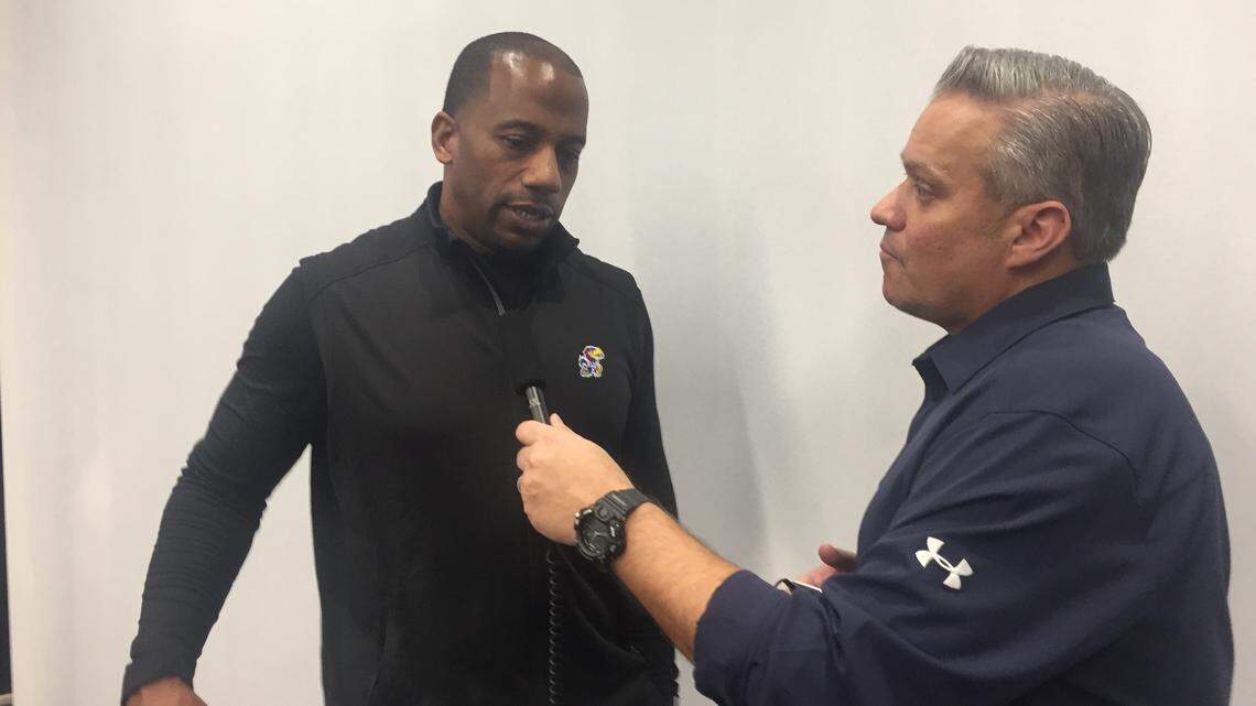 Kansas football receivers coach/passing game coordinator Emmett Jones, left, talks to a reporter during an interview in on Feb. 6, 2019, at KU’s Anderson Family Football Complex.