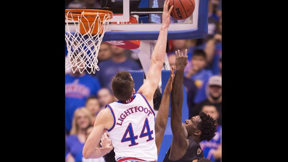 Kansas Jayhawks forward Mitch Lightfoot (44) got his hand on a shot by Oakland Golden Grizzlies guard Kendrick Nunn (1) on Friday, November 24, 2017, at Allen Fieldhouse.