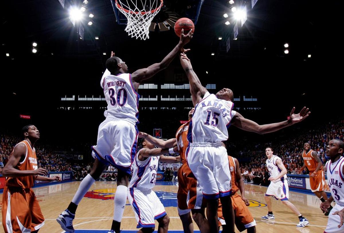 Kansas’ Julian Wright snags a rebound from teammate Mario Chalmers during the Jayhawks’ game against Texas in Lawrence, Kansas, Saturday, March 3, 2007. The Jayhawks defeated the Longhorns 90-86.